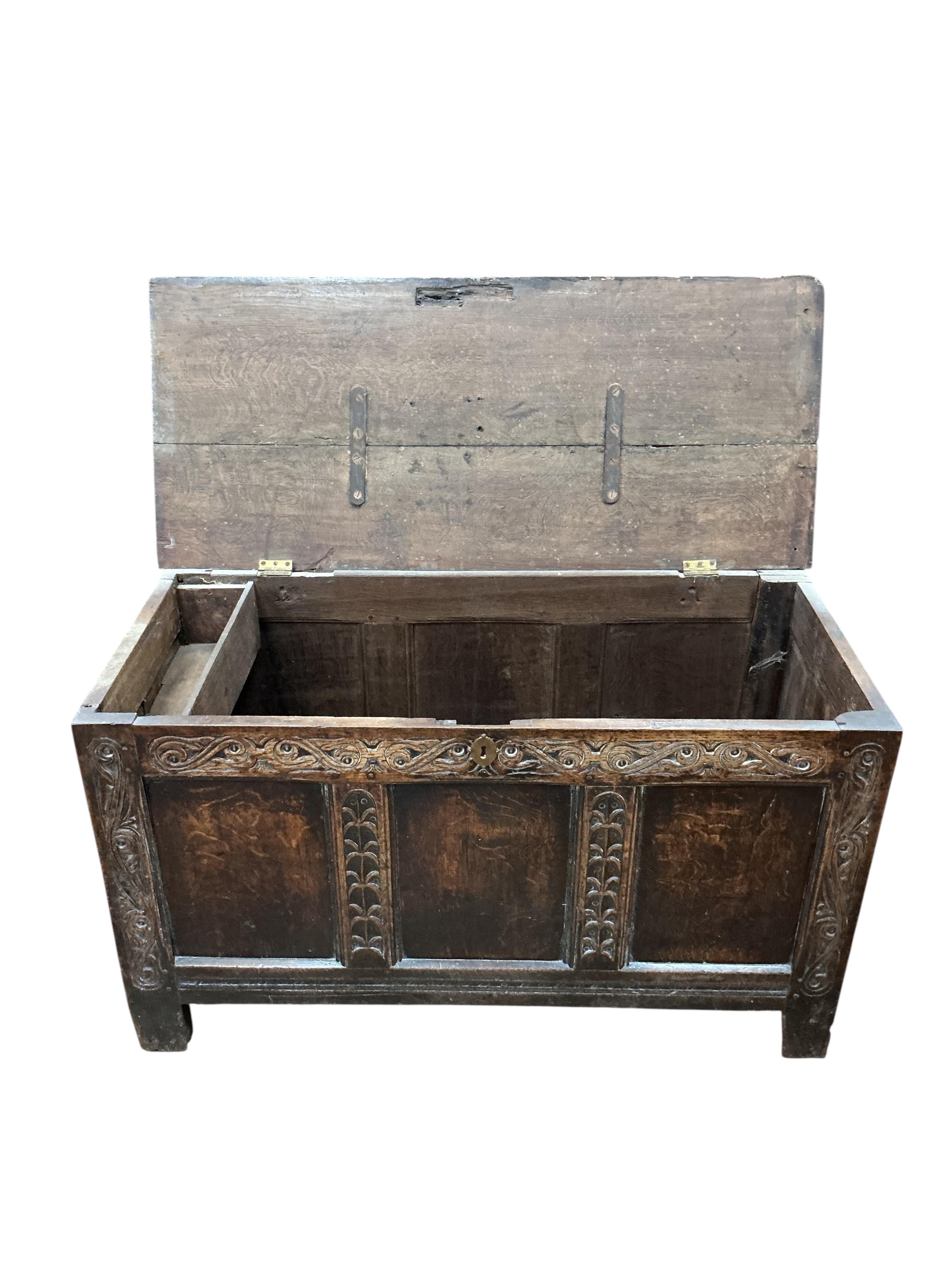 An 18th century panelled oak coffer, width 111cm, depth 48cm, height 65cm